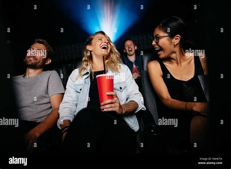 Young Woman With Friends In Cinema Hall Watching Movie Group Of People