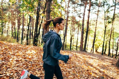 Runner Woman Jogging In Autumn Park — Stock Photo © Chesterf 86997194