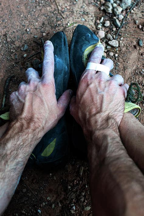 A Climbers Hands Grabbing His Feet Photograph By Cavan Images
