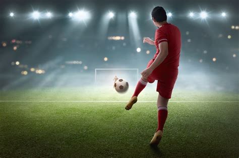 Young Asian Soccer Player Shooting The Ball Premium Photo