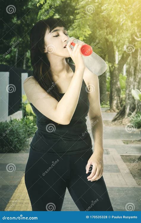 Portrait Of Beautiful Woman Drinking After Workout Stock Photo Image