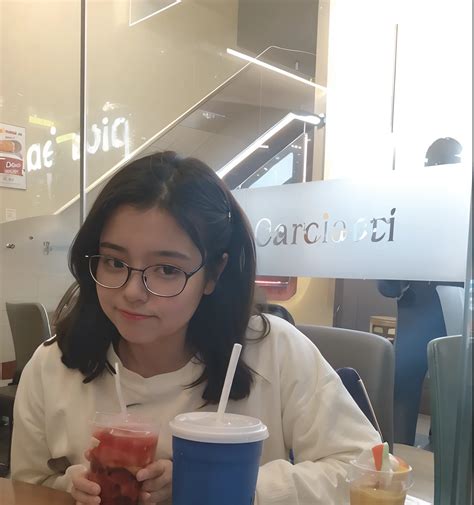 There is a woman sitting at a table with a drink and a drink - SeaArt AI