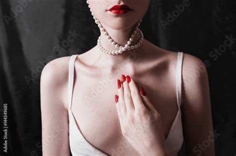 The Long Neck And Beautiful Clavicle Woman Wearing A Necklace Of Beads On A Black Background