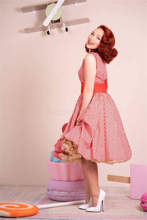 Beautiful Red Haired Pinup Smiling Happily Girl Posing In A Retro Red
