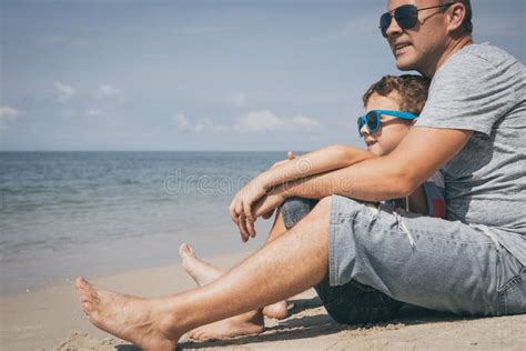 Father And Son Playing On The Beach At The Day Time Stock Image My
