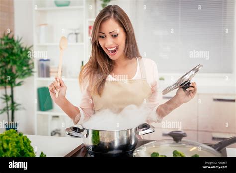 Cheerful Beautiful Woman Cooking In The Kitchen Stock Photo Alamy