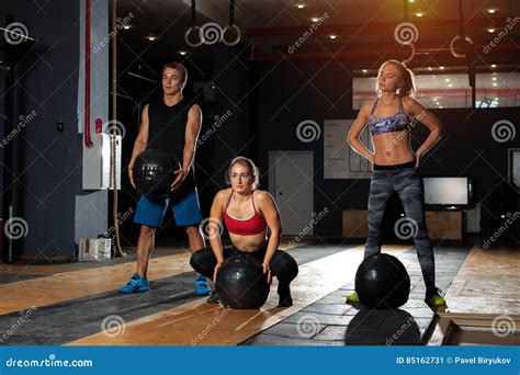 Muscular Adults Exercising With Heavy Balls In Gym Stock Image Image Of Endurance Slim