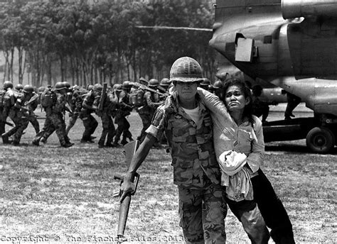 An Exhausted Woman Is Helped By A South Vietnamese Soldier After The