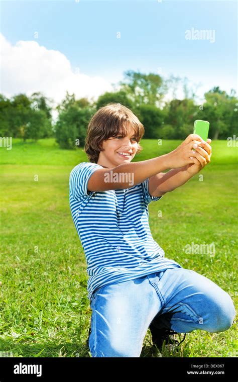 14 Years Old Boy Taking A Picture Of Himself With Camera On The Cell