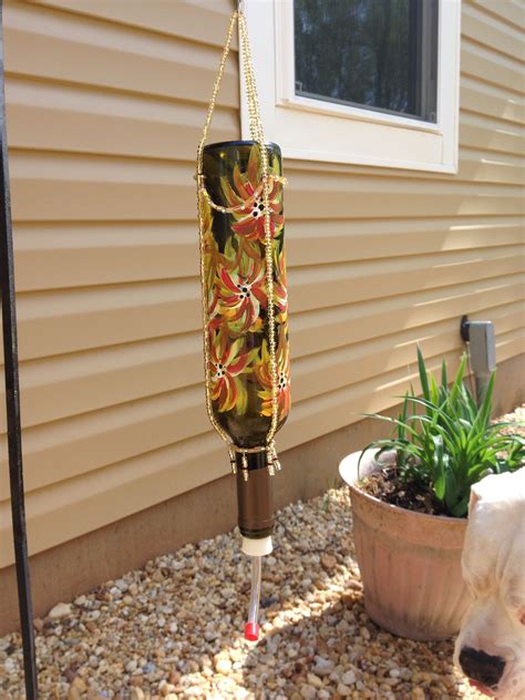 You can use these simple designs to attract bluebirds, swallows, chickadees, nuthatches, warblers, woodpeckers, wrens, and other birds to your garden. Hand painted hummingbird feeder. Old wine bottle, some ...