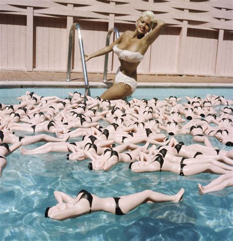 jayne mansfield posing with water bottle likenesses in her pool hollywood 1957 ~ vintage everyday