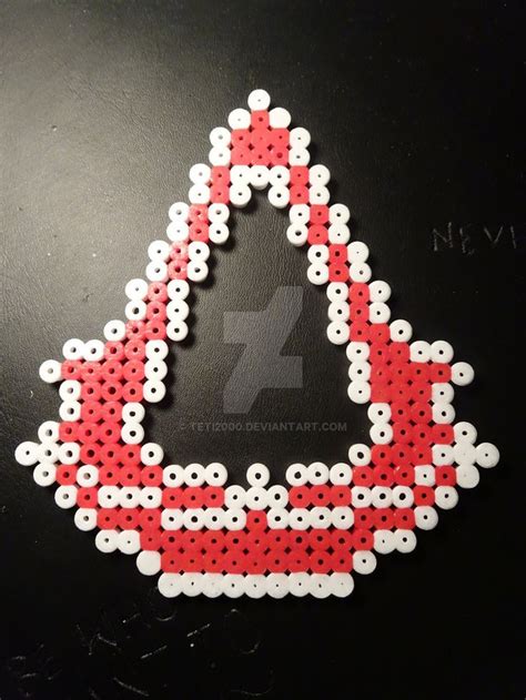 A Red And White Triangle Shaped Sticker On Top Of A Black Surface With