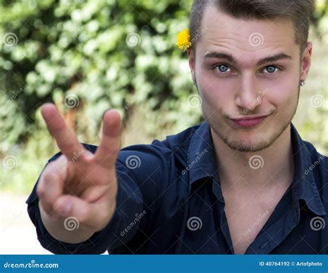 Attractive Young Blond Man Doing Peace Sign Stock Photo Image Of Grin