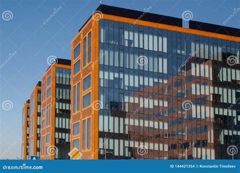 Image Of Modern Yellow Office Buildings Against A Blue Sky Stock Photo