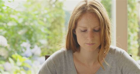 Young Redhead Woman Praying At Home Slow Motion Shot Stock Video