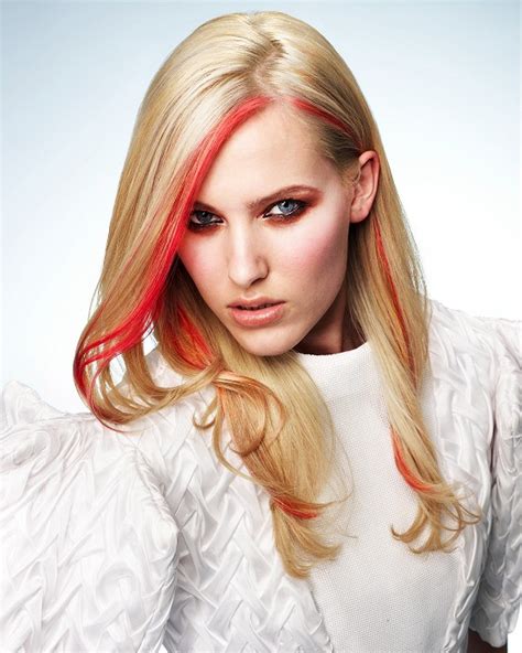 This blonde hair color is neither too glossy nor flashy and isn't too pale, creamy or greys at the same time. Long, blond hairstyle with single red coloured streaks of ...