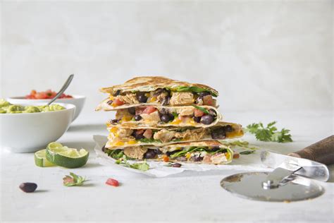 Zesty chicken and cooked peppers are a tasty delight when mixed with cheese and stuffed in a tortilla to create chicken quesadillas. Chicken and Spinach Quesadillas