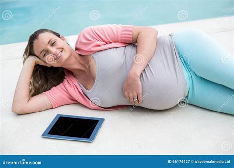 Pregnant Woman Relaxing Outside Using Tablet Stock Image Image Of Massaging Homey 66174427