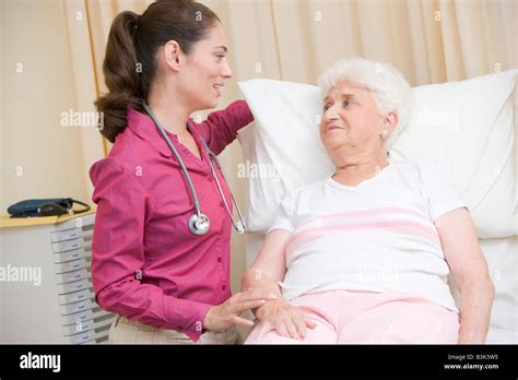 Doctor Giving Checkup To Woman In Exam Room Stock Photo Alamy
