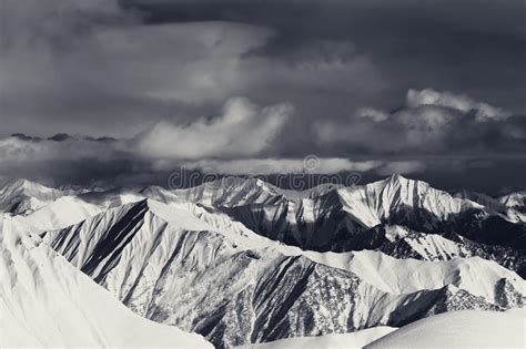 Sunlight Snowy Mountains And Storm Clouds Stock Photo Image Of