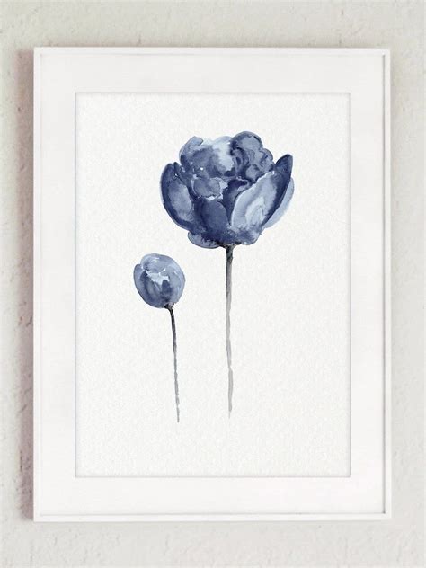 Two Blue Flowers Are In A White Frame