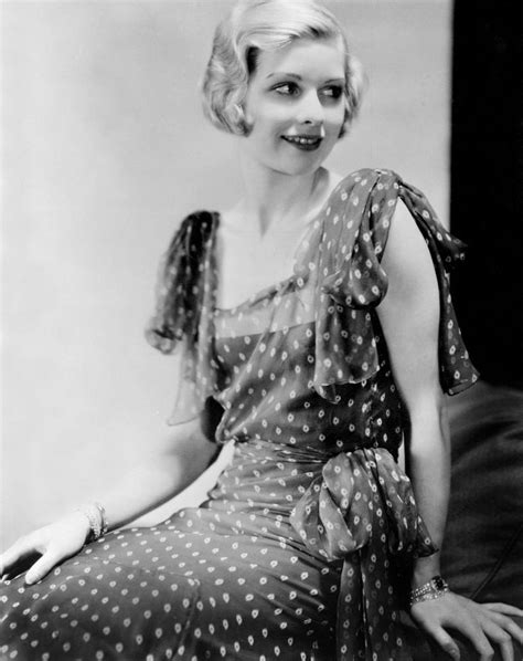 A Black And White Photo Of A Woman Wearing A Polka Dot Dress