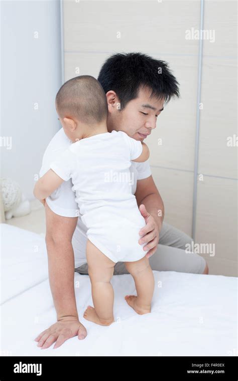 Tender Moment Between Chinese Father And Son Real People Stock Photo