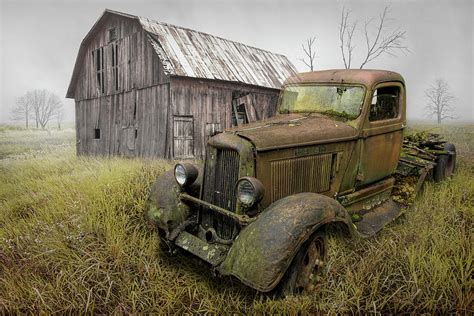 rusted vintage dodge truck by an old weathered barn photograph by