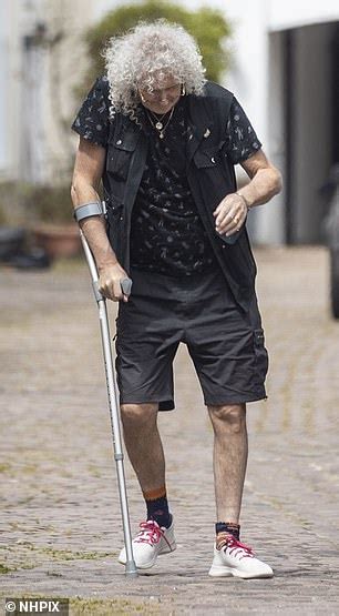 brian may walks with the aid of a crutch as he emerges after heart attack daily mail online