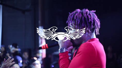 Lil Uzi Vert Is Singing In Front Of Audience Wearing Red Dress In Black