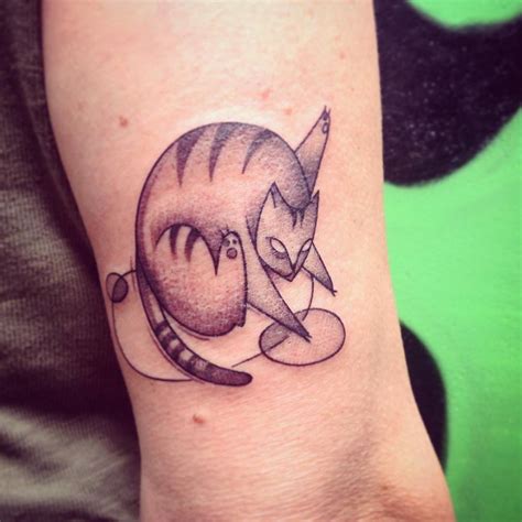 Abstract Cat Tattoo On The Tricep
