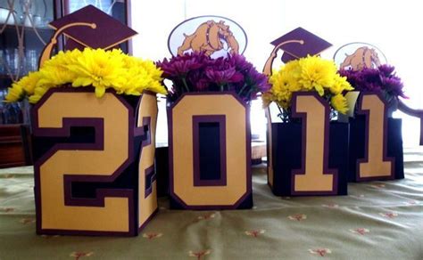 Three Vases With Flowers In Them Sitting On A Table Next To The Numbers