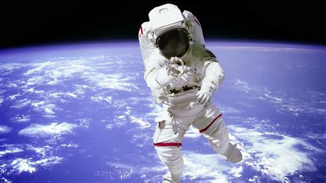 Astronaut Outside The International Space Station On A Spacewalk With A