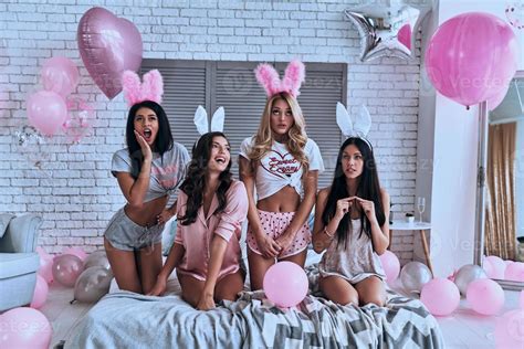 Girls Time Four Playful Young Women In Bunny Ears Making A Face And