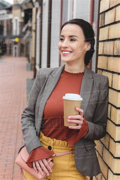 Happy Beautiful Stylish Woman Holding Coffee In Paper Cup And Leaning