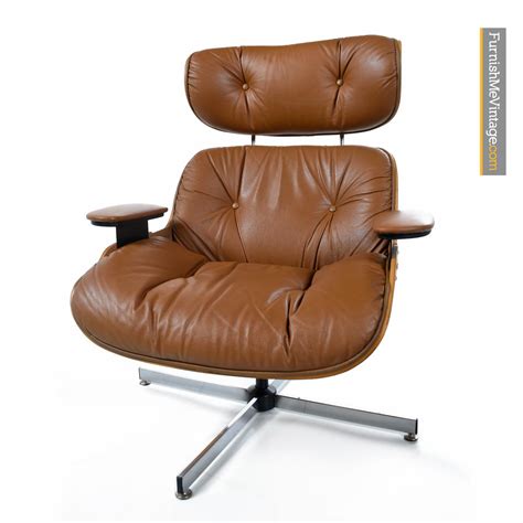 Black feet support the body characterized by white leather upholstery and button tufting. Mid-Century Modern Eames Style Lounge Chair and Ottoman