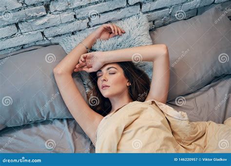 Young Beautiful Woman Lying And Relaxing In Bed In Her Bedroom Stock