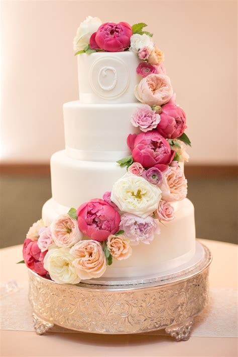 A wedding cake is one of the most important wedding elements that is very much capable of making the guest fall head over heel in love with you and your wedding. Cascading Ranunculus and Peony Wedding Cake #weddingcake # ...