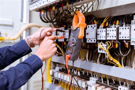 Premium Photo Electrician Testing Electric Current In Control Panel