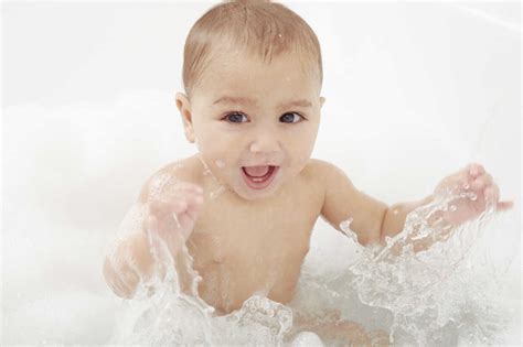 Baby Splashing In Bathtub Stock Photo