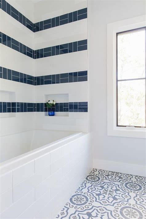 Glossy Blue Tiles Are Striped Across White Subway Surround Tiles