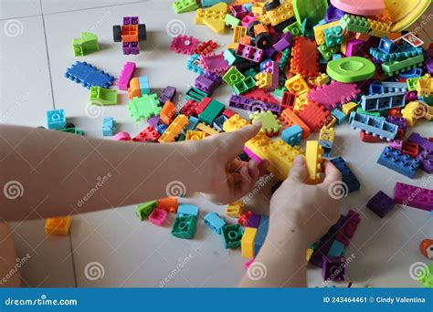 Building And Playing Lego On Top Of Scattered Legos On The Floor Stock