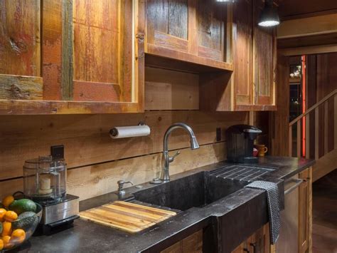 The oven usually sits at one of the ends of the countertop and the sink sits either beside it or on the other end. Upper and lower cabinets feature a natural wood finish ...
