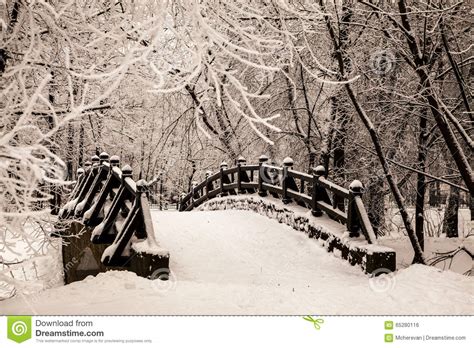 Beautiful Old Stone Bridge Of Winter Forest In The Snow At