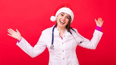 Premium Photo A Cheerful Nurse In A White Coat On A Red Background