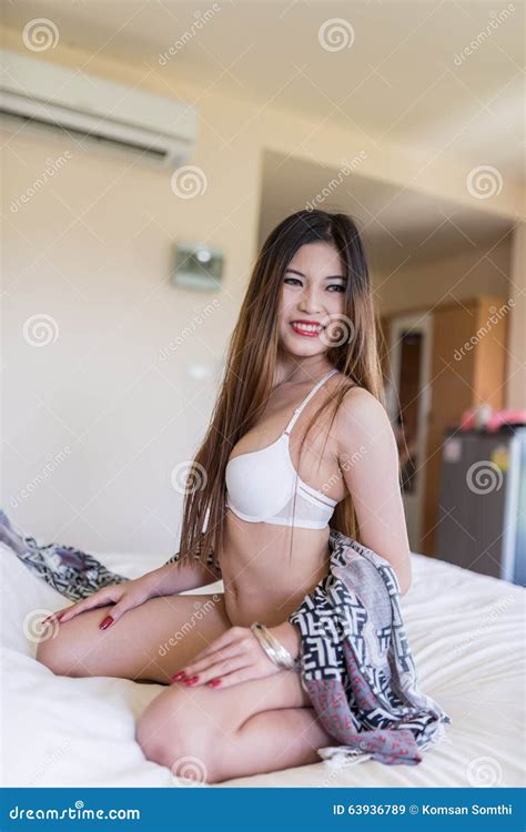 Beautiful Brunette Woman Lying In Bed In Sensual Lingerie Looking At Camera Stock Image