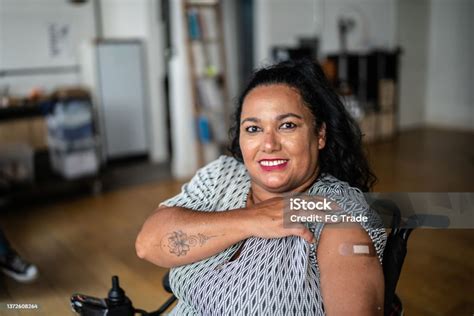 Portrait Of A Disabled Mature Woman Showing Her Arm After Vaccination