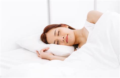 Portrait Of Relaxed Beautiful Asian Woman Sleeping On White Bed In The Bedroom In The Morning