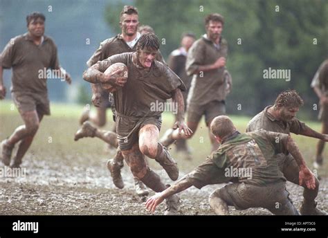 Muddy Rugby Player Running In Mud With Ball Competition Winning Sports