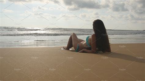 Beautiful Young Woman In Bikini Lying On Golden Sand On Sea Beach And